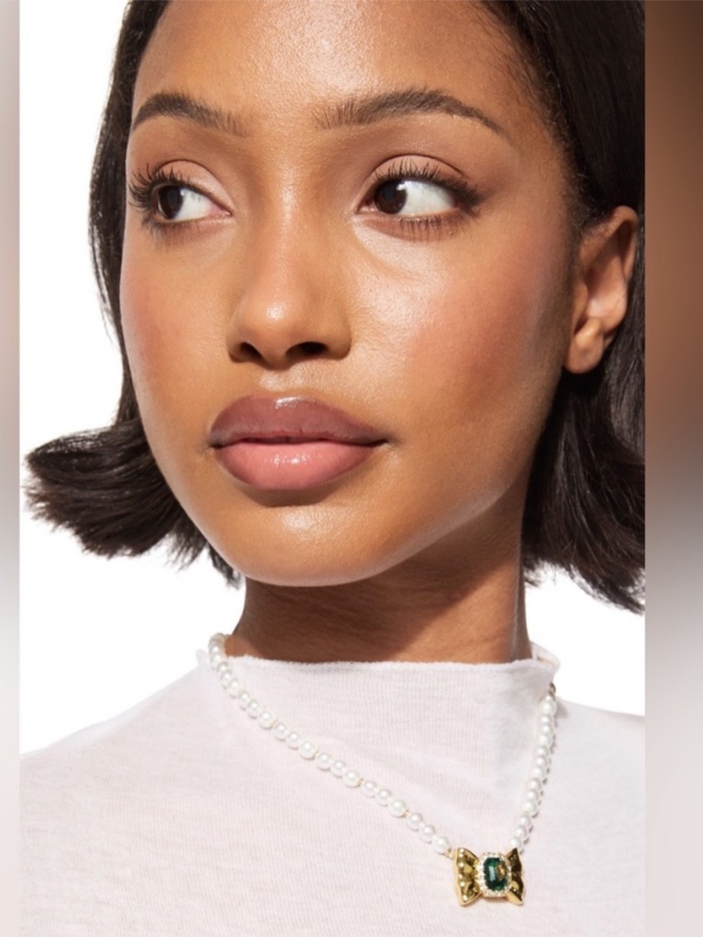 Kurt Geiger Pearl Necklace with Gold Bow Pendant and Green Gem